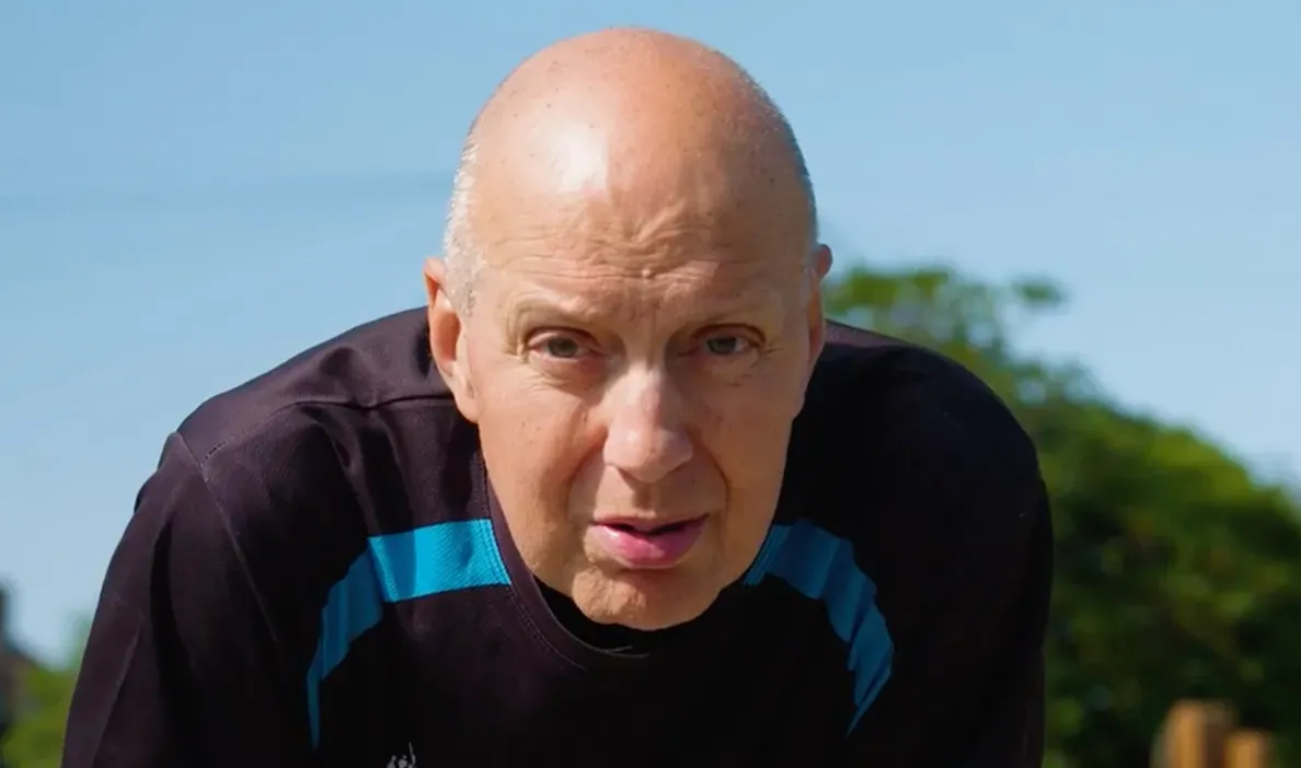 Man wearing sports clothing about to go for a run.