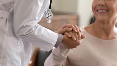 Doctor holding hands with a female patient